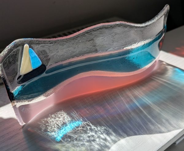 Atlantic Beach glass art featuring pink sand, ocean and boat.